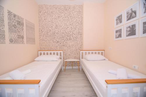 a room with two beds and a table at Lovely apartment Lungomare in Vlorë