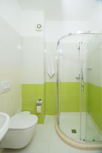 a bathroom with a shower and a toilet and a sink at Lovely apartment Lungomare in Vlorë