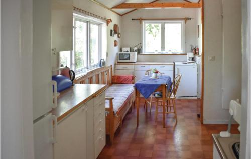a kitchen with a table with a blue table cloth at Cozy Home In Djurhamn With Wifi in Djurhamn