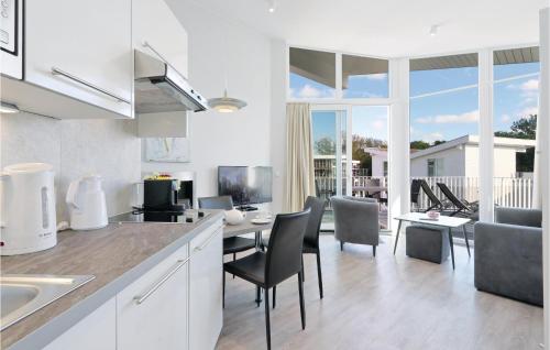 a kitchen and living room with a table and chairs at Dünenvilla 14, Whg 9 in Priwall
