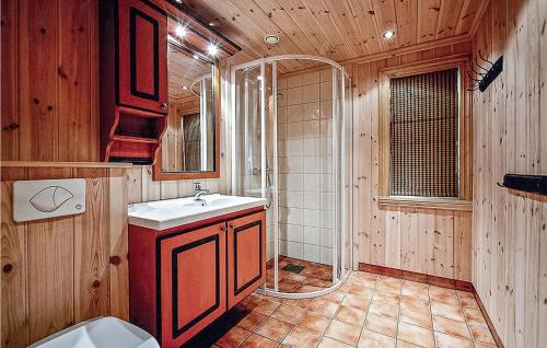 a wooden bathroom with a sink and a shower at Lovely Home In Hemsedal With Wifi in Hemsedal