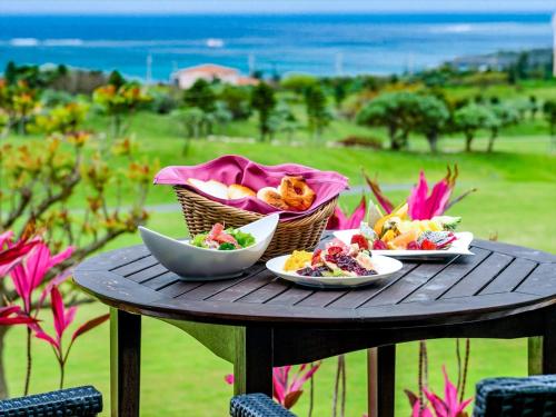 a table with three plates of food on it at Shigira Bayside Suite Allamanda in Miyako Island