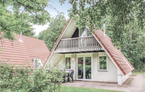 a white house with a porch with a deck at 3 Bedroom Beautiful Home In Gramsbergen in Gramsbergen