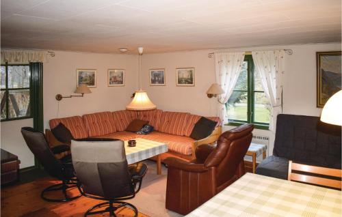a living room with a couch and a table and chairs at Lovely Home In Gemla With Sauna in Gemla