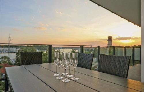 a table with wine glasses on top of a balcony at Highend Travemünde - Whg 408 in Travemünde