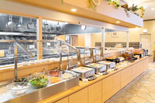 a restaurant kitchen with a buffet line of food at Hotel The West Hills Mito in Mito