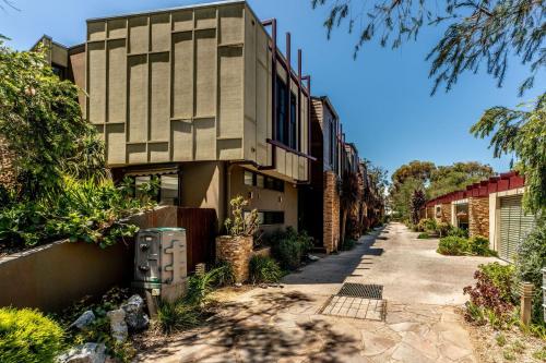 a building with a sidewalk next to a street at Serenity by the Sea Inverloch in Inverloch