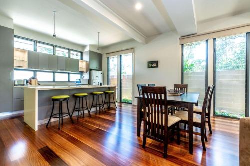 a kitchen and dining room with a table and chairs at Serenity by the Sea Inverloch in Inverloch