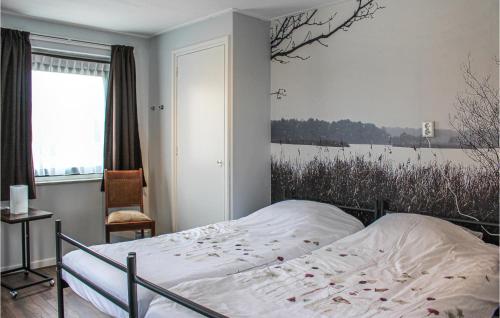 a bedroom with a bed with a painting on the wall at Awesome Home In Acquoy With Wifi in Acquoy