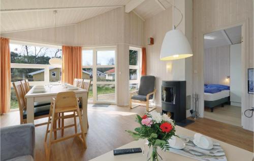 a kitchen and living room with a table and a dining room at Freibeuterweg 10 - Dorf 6 in Priwall