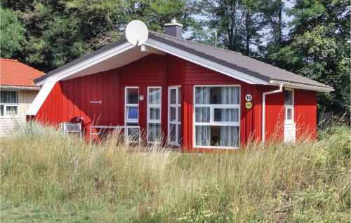 a red barn with a white door and a window at Freibeuterweg 10 - Dorf 6 in Priwall