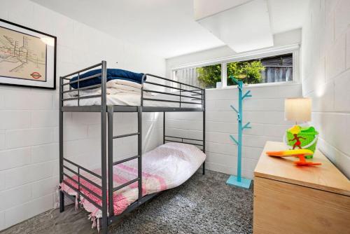 a bedroom with a bunk bed and a desk with a lamp at 1 Luana in Lorne