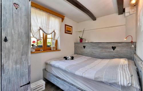 a bedroom with a bed with a wooden headboard at Lovely Home In Beretinec With Wifi in Beretinec