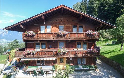 a large wooden house with flowers on the balcony at Schoenes Ferienhaus Zillertal in Hart im Zillertal