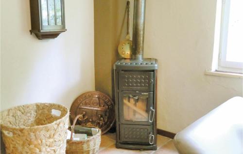 a stove in a corner of a room with baskets at Gorgeous Home In Vianden With Wifi in Vianden