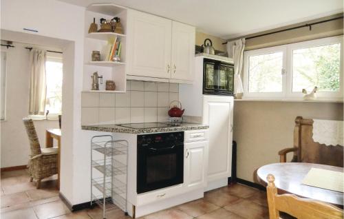 a kitchen with white cabinets and a stove top oven at Gorgeous Home In Vianden With Wifi in Vianden