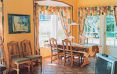 a dining room with a table and chairs and a window at Holiday Home Östra Berga Lysvik in Lysvik