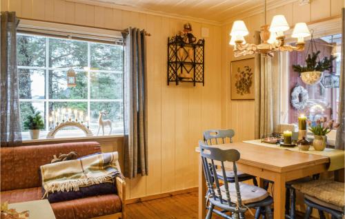 a kitchen with a table and a dining room at Heggebu in Vråliosen