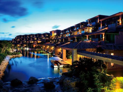 a view of a resort with a river at night at Shigira Bayside Suite Allamanda in Miyako-jima