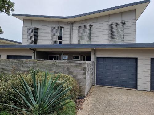 a house with a fence and a garage at At Broadbeach Inverloch in Inverloch