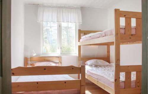 two bunk beds in a room with a window at Stunning Home In Ystad With 3 Bedrooms And Wifi in Ystad