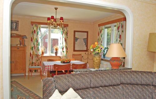 a living room with a couch and a dining room at Holiday Home Tosthult Lönsboda Lönsboda in Falsehult