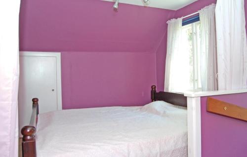 a purple bedroom with a bed and a window at Holiday Home Tosthult Lönsboda Lönsboda in Falsehult