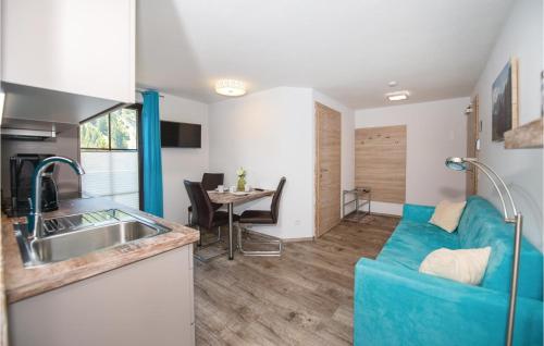 ラウリスにあるStunning Apartment In Rauris With 1 Bedrooms And Wifiのリビングルーム(青いソファ、テーブル付)