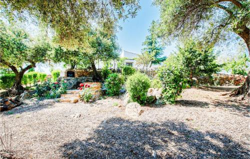 a garden with trees and a house in the background at Awesome Home In Constantina With Wifi in Constantina