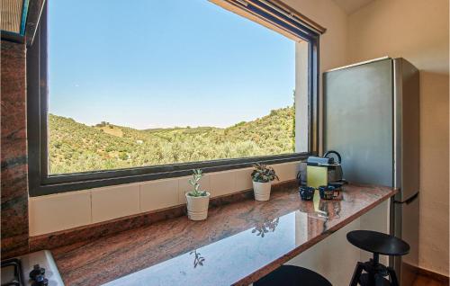 a room with a large window with plants on a counter at Awesome Home In Constantina With Wifi in Constantina