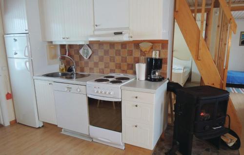 a small kitchen with a stove and a sink at Lovely Home In Sävsjö With Wifi in Sävsjö