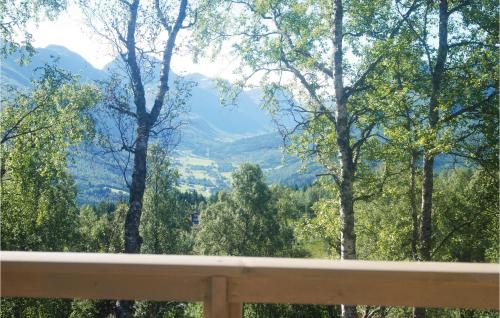 a view of a mountain valley from a wooden railing at Stunning Home In Stranda With Sauna in Stranda