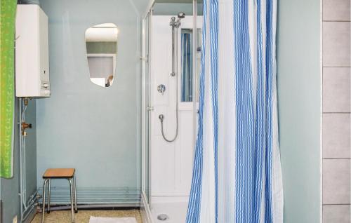 a bathroom with a shower curtain and a stool at 1 Bedroom Nice Home In Lierneux in Lierneux