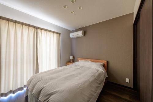 Rakuten STAY HOUSE x WILL STYLE Sasebo 102 tesisinde bir odada yatak veya yataklar
