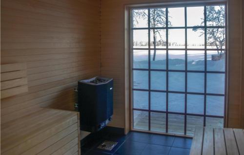 a room with a television and a large window at Stunning Home In Vaggeryd With Sauna in Vaggeryd