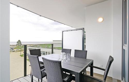 a dining room with a table and chairs on a balcony at Highend Travemünde - Whg 215 in Travemünde