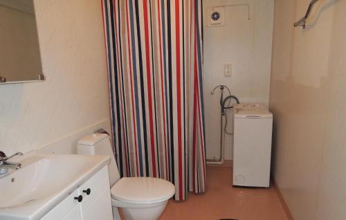 a bathroom with a toilet and a shower curtain at Stunning home in Nssj with 3 Bedrooms and WiFi in Barkansjö