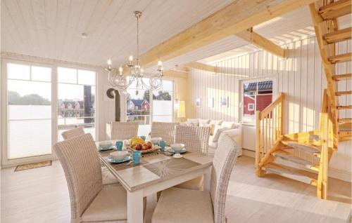 a dining room with a table and chairs at 2 Bedroom Lovely Home In Zerpenschleuse in Zerpenschleuse