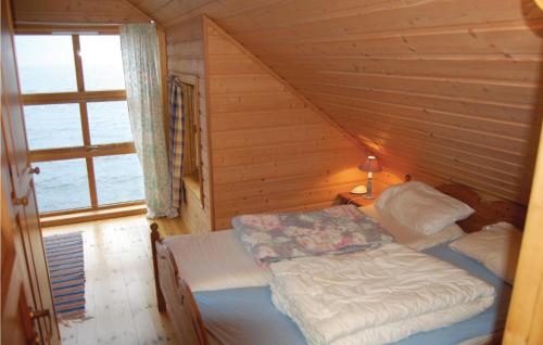a bedroom with a bed in a wooden cabin at Amazing Apartment In Rosendal With Sauna in Rosendal