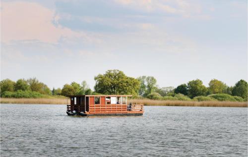 a small boat in the middle of a lake at Stunning Ship In Radewege With Kitchen in Radewege