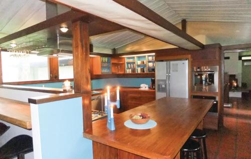 a kitchen with a wooden table and a refrigerator at Beautiful Home In Strängnäs With Sauna in Aspö