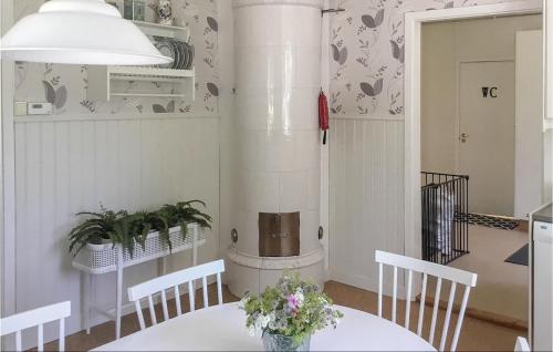 a dining room with a table and a heater at 4 Bedroom Nice Home In Mullsjö in Mullsjö