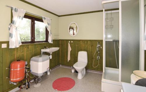 a bathroom with a toilet and a sink and a shower at Amazing Home In Stenkullen With 1 Bedrooms And Wifi in Stenkullen