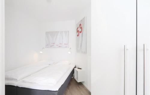 a small white room with a bed in it at Promenadenvilla in Travemünde