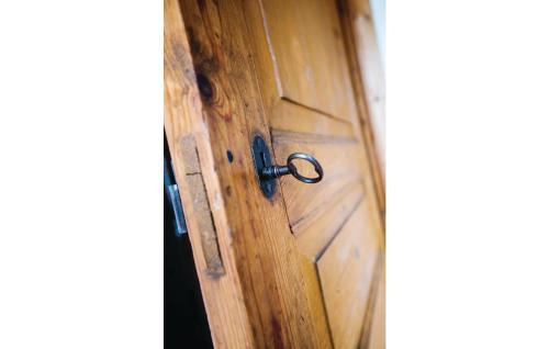 a wooden door with a lock on it at Holiday Home Skogstorp Gård Holmsjö in Holmsjö