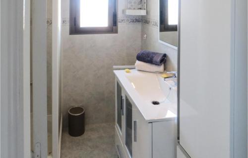 a white bathroom with a sink and a mirror at Lovely Apartment In Quesada With House A Mountain View in Rojales