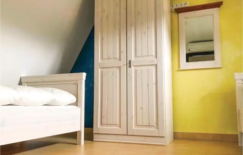 a bedroom with a white closet and a white bed at Awesome Home In Loddin With 2 Bedrooms, Sauna And Wifi in Loddin