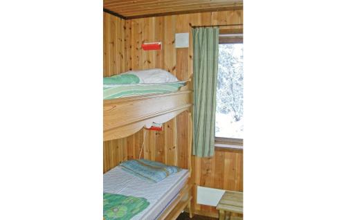 a bedroom with two bunk beds and a window at Nice Home In Slen With Wifi in Våtkölssätern