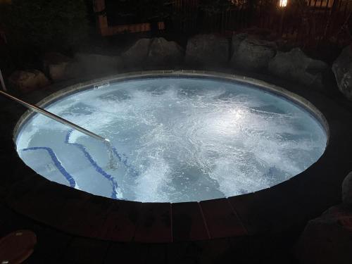 a hot tub filled with water in a dark room at Allegheny Spring 239 KING, bed/Ski-In, Out/Pool & Hot Tub in Snowshoe