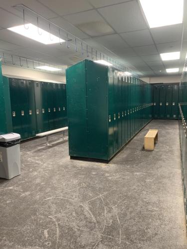 a locker room with green lockers and a bench at Allegheny Spring 239 KING, bed/Ski-In, Out/Pool & Hot Tub in Snowshoe